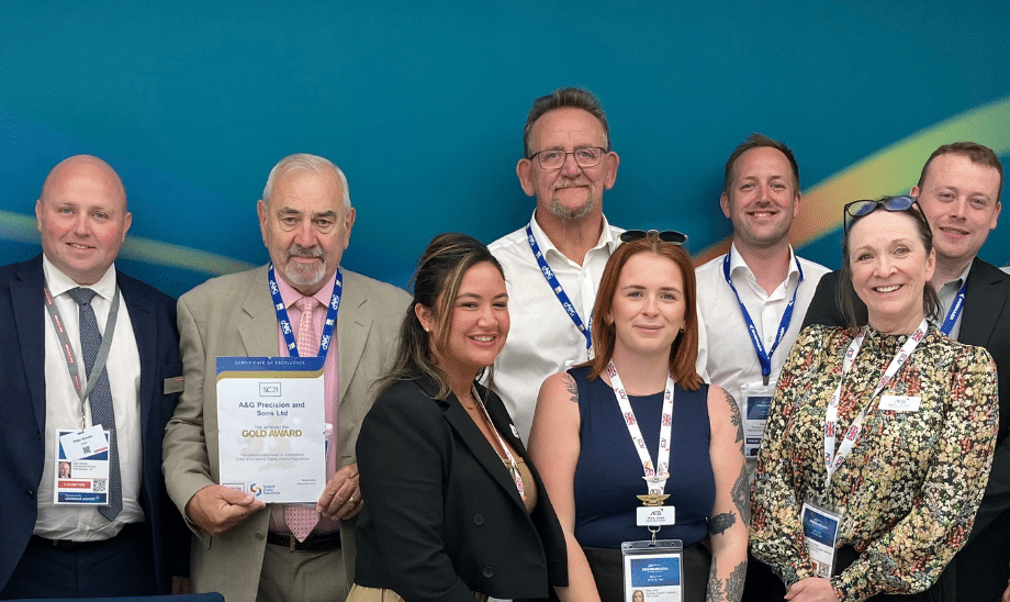 Group photo of team members smiling with a certificate for the SC21 Gold Award, celebrating excellence in aerospace and defence supply chain performance.