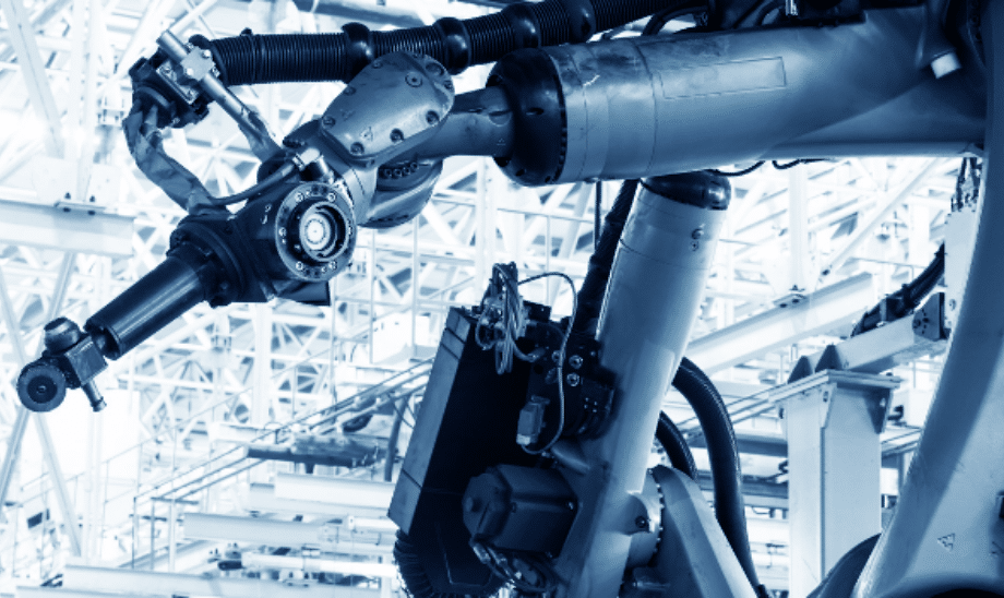 Close-up of an advanced robotic arm operating in a modern, high-tech automated manufacturing environment